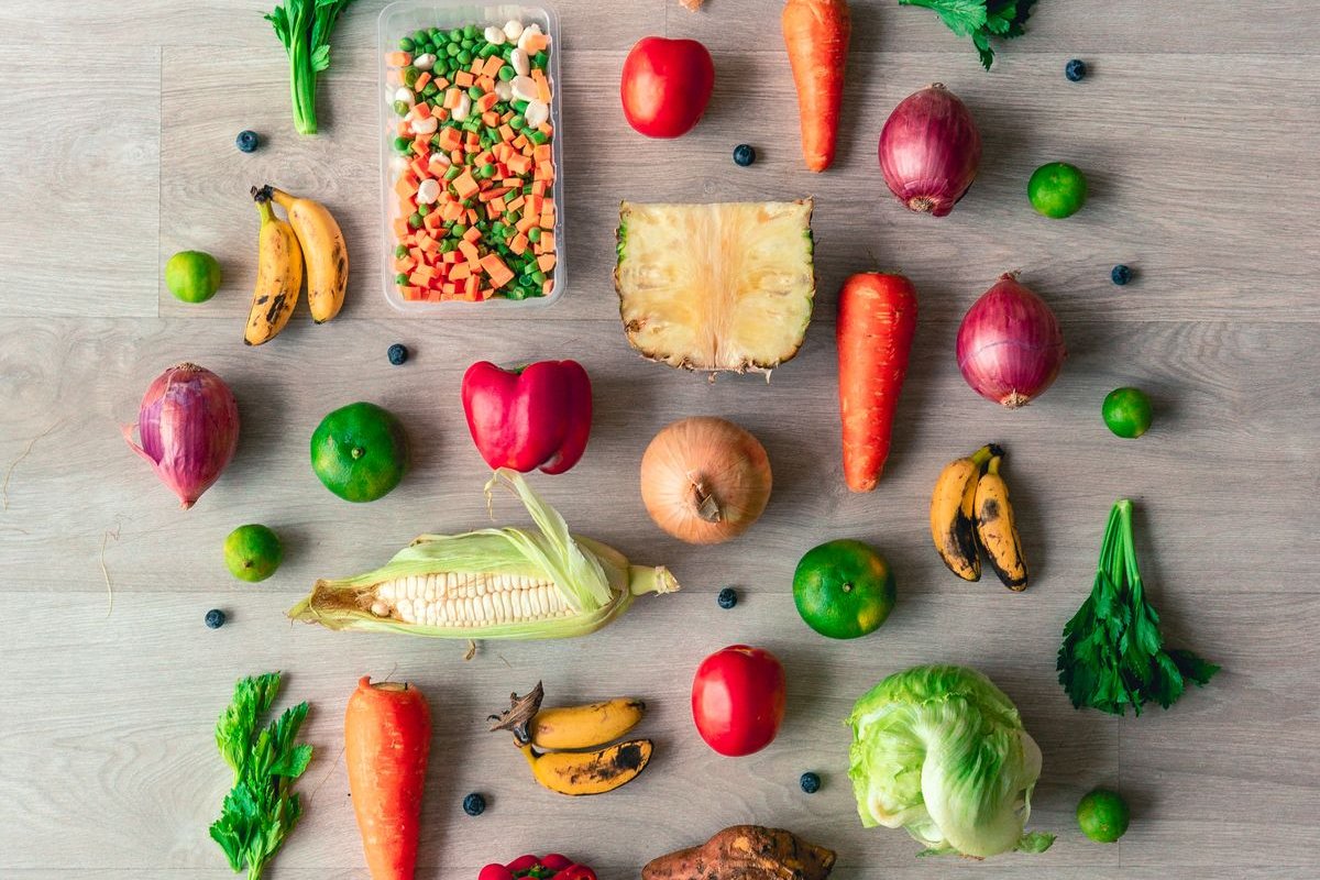 Fruits and vegetables laid out on a wooden floor